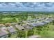 An aerial view shows a residential area with community pool and golf course at 9123 Raes Creek Pl, Palmetto, FL 34221