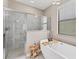 Bathroom featuring a glass door shower, freestanding tub, and a wooden bath caddy at 9123 Raes Creek Pl, Palmetto, FL 34221
