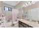 Bright bathroom with shower and tub combination, single sink vanity, and tile floors at 9123 Raes Creek Pl, Palmetto, FL 34221
