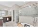 Bathroom with glass-door shower, freestanding tub, dual sink vanity with granite counters at 9123 Raes Creek Pl, Palmetto, FL 34221