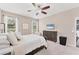 Bright bedroom with large windows, cozy furnishings, and a ceiling fan at 9123 Raes Creek Pl, Palmetto, FL 34221