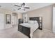 Neutral bedroom featuring carpeted floors, natural light, and a comfortable bed at 9123 Raes Creek Pl, Palmetto, FL 34221