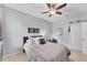A bedroom painted with light blue color, ceiling fan and a large window at 9123 Raes Creek Pl, Palmetto, FL 34221
