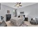 Cozy bedroom with a ceiling fan, a comfortable bed and matching furniture at 9123 Raes Creek Pl, Palmetto, FL 34221
