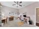 Spacious craft room with ceiling fan, sewing station with sewing machine and desk at 9123 Raes Creek Pl, Palmetto, FL 34221