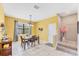 Charming dining room with bright yellow walls and table setting next to a stairway at 9123 Raes Creek Pl, Palmetto, FL 34221