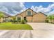 Traditional home with a three-car garage, manicured lawn, and trimmed hedges at 9123 Raes Creek Pl, Palmetto, FL 34221