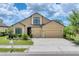 Traditional home with a three-car garage, manicured lawn, and trimmed hedges at 9123 Raes Creek Pl, Palmetto, FL 34221
