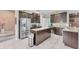 Modern kitchen featuring stainless steel appliances, a granite-topped island, and ample cabinet space at 9123 Raes Creek Pl, Palmetto, FL 34221