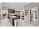 Open kitchen with granite counters, stainless appliances, dark cabinets, island, and seating area at 9123 Raes Creek Pl, Palmetto, FL 34221