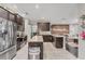 Spacious kitchen with dark cabinets, granite counters, stainless appliances and bar stool seating at 9123 Raes Creek Pl, Palmetto, FL 34221