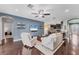 Bright, open living room with modern decor, hardwood floors, and comfortable seating arrangement at 9123 Raes Creek Pl, Palmetto, FL 34221