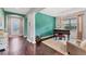 Open-concept living room featuring decorative columns, dark hardwood floors, and large windows at 9123 Raes Creek Pl, Palmetto, FL 34221