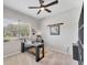 Bright home office with large window, ceiling fan, and unique decor at 9123 Raes Creek Pl, Palmetto, FL 34221