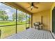 Covered porch with grill and views of a well-manicured lawn at 9123 Raes Creek Pl, Palmetto, FL 34221