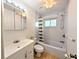Bathroom featuring a shower-tub combo, matching toilet and sink, and a window at 1540 Pleasant Rd # G35, Bradenton, FL 34207