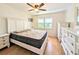 Bedroom featuring wood floors, a ceiling fan, and a large window at 1540 Pleasant Rd # G35, Bradenton, FL 34207