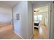Hallway leading to the primary bedroom, showcasing wood floors and light grey walls at 1540 Pleasant Rd # G35, Bradenton, FL 34207