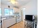 Bright kitchen featuring white cabinets, laminate floors and modern appliances at 1540 Pleasant Rd # G35, Bradenton, FL 34207