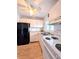 Cozy kitchen featuring white appliances, laminate floors, and ceiling fan at 1540 Pleasant Rd # G35, Bradenton, FL 34207