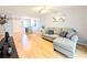 Open living room features laminate flooring, a ceiling fan and neutral walls at 1540 Pleasant Rd # G35, Bradenton, FL 34207