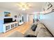 Open living room features laminate flooring, a ceiling fan and neutral walls at 1540 Pleasant Rd # G35, Bradenton, FL 34207