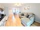 Open living room features laminate flooring, a ceiling fan and neutral walls at 1540 Pleasant Rd # G35, Bradenton, FL 34207