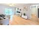 Open living room features laminate flooring, a ceiling fan and neutral walls at 1540 Pleasant Rd # G35, Bradenton, FL 34207