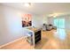 Bright living room with wood floors, bar table, and a sliding glass door to the outside at 1540 Pleasant Rd # G35, Bradenton, FL 34207