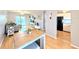 Open-concept living room and kitchen features laminate floors, ceiling fan and lots of light at 1540 Pleasant Rd # G35, Bradenton, FL 34207