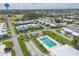 An aerial view showcases community pool, shuffleboard courts, and well-kept landscaping at 1060 Cockrill St # 1060, Venice, FL 34285