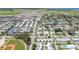 Wide aerial view of a residential community near an airport with lush green spaces and tidy streets at 1060 Cockrill St # 1060, Venice, FL 34285
