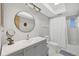 Bathroom featuring a vanity with round mirror, updated fixtures, and walk-in shower at 1060 Cockrill St # 1060, Venice, FL 34285