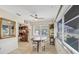 Cozy dining area with natural light, ceiling fan, and a decorative mirror at 1060 Cockrill St # 1060, Venice, FL 34285