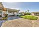 Spacious driveway leading to a well-maintained home with patio and carport at 1060 Cockrill St # 1060, Venice, FL 34285