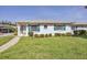 Charming single-story home with white exterior, green shutters, and a well-manicured lawn in a tranquil neighborhood at 1060 Cockrill St # 1060, Venice, FL 34285