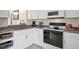 Bright kitchen featuring granite countertops, white cabinetry, and modern appliances at 1060 Cockrill St # 1060, Venice, FL 34285