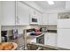 Well-lit kitchen featuring white cabinetry, granite countertops, and stainless appliances at 1060 Cockrill St # 1060, Venice, FL 34285