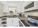 Efficient kitchen layout featuring modern appliances, granite countertops, and white cabinets for a clean, bright space at 1060 Cockrill St # 1060, Venice, FL 34285