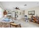 Comfortable living room with tile flooring, ceiling fan, and seamless flow into dining area and kitchen at 1060 Cockrill St # 1060, Venice, FL 34285
