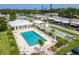 Relaxing pool area offers a large pool, shuffleboard and plenty of seating with lush tropical landscaping at 1060 Cockrill St # 1060, Venice, FL 34285