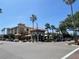 Street view of restaurants on a sunny day in Venice Florida with palm trees at 1060 Cockrill St # 1060, Venice, FL 34285