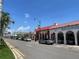 Street view of commercial buildings and palm trees on a sunny day in Venice Florida at 1060 Cockrill St # 1060, Venice, FL 34285