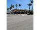 Street view of commercial buildings on a sunny day in Venice Florida with palm trees at 1060 Cockrill St # 1060, Venice, FL 34285