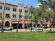 Commercial building view with pedestrian crosswalk and palm tree lined street on a sunny day at 1060 Cockrill St # 1060, Venice, FL 34285