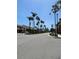 Street view of buildings and palm trees on a sunny day in Venice Florida at 1060 Cockrill St # 1060, Venice, FL 34285
