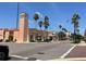 View of the Venice Theatre, with its peach exterior, white columns, and red tiled roof at 1060 Cockrill St # 1060, Venice, FL 34285