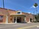 View of the Venice Theatre, with its peach exterior, white columns, and red tiled roof at 1060 Cockrill St # 1060, Venice, FL 34285