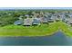 An aerial view of a community showing backyards, green space, and a scenic pond at 10609 Great Cormorant Dr, Riverview, FL 33579