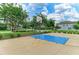 Community basketball court with lush green trees and landscaping, perfect for outdoor activities at 10609 Great Cormorant Dr, Riverview, FL 33579